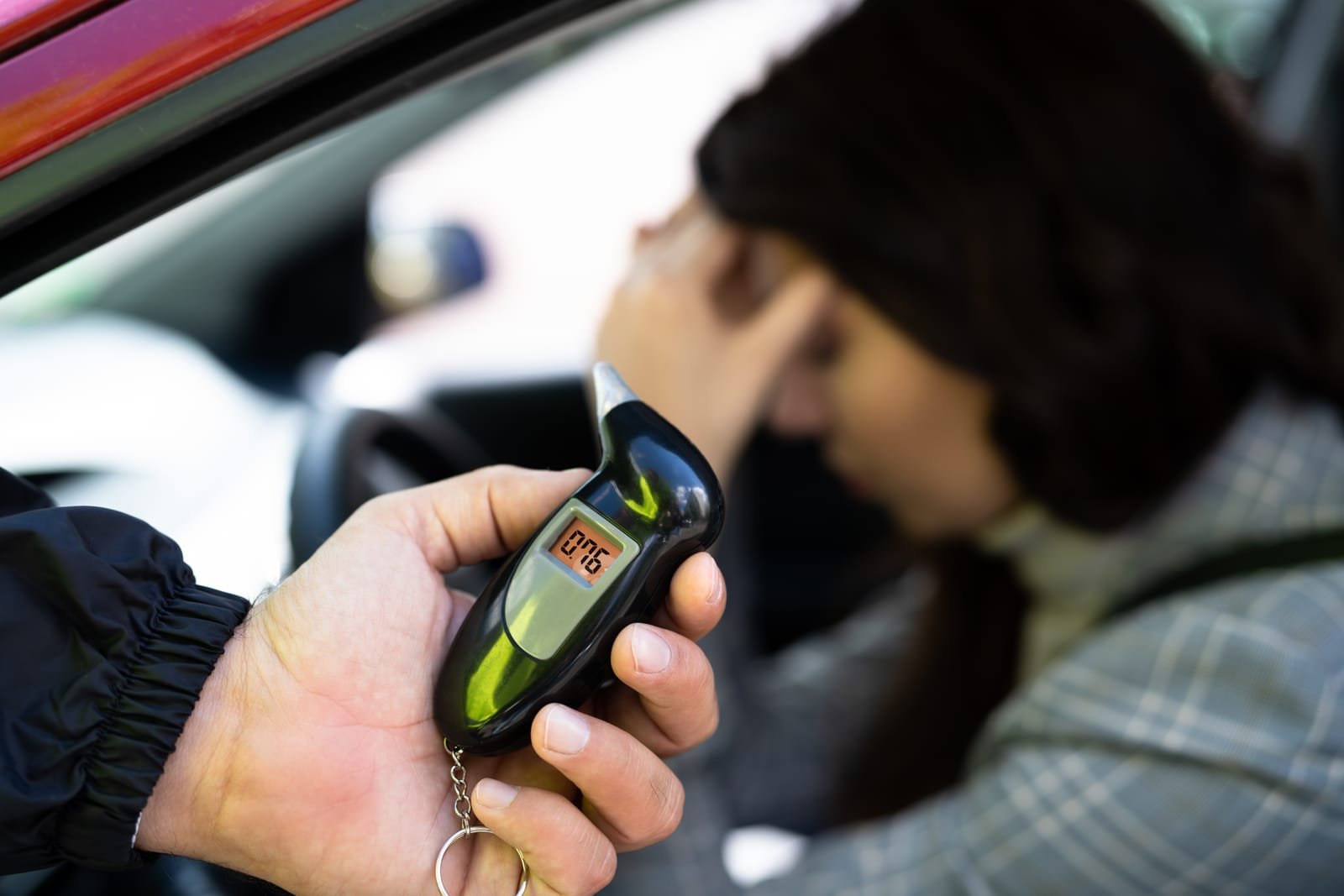 Woman taking a breathalyzer test.