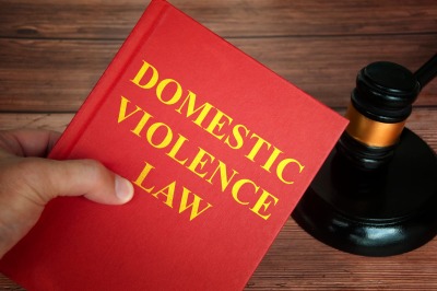 83383102_domestic-violence-law-text-on-law-book-with-judge-gavel-on-wooden-desk-background.jpg